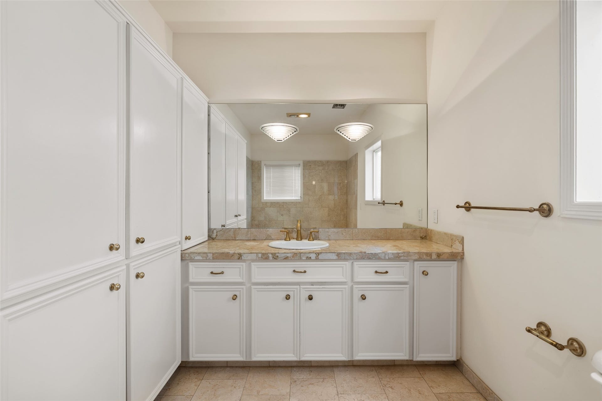 3923 Childress Street, #A, Houston, TX 77005 One of 2 primary spacious bathrooms, this one featuring a soaking tub with marble countertops, ample cabinet storage, and a large mirror enhancing natural light.