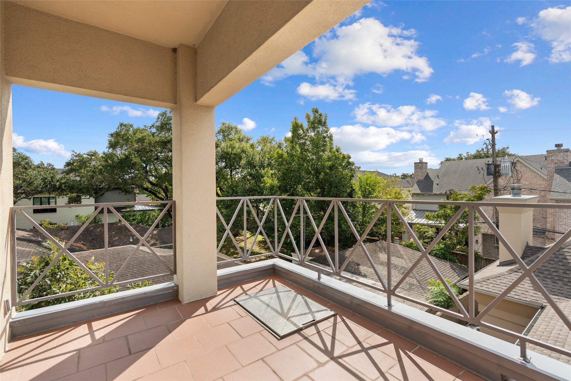 3923 Childress Street, #A, Houston, TX 77005 Spacious balcony with a charming view of lush trees and rooftops, perfect for enjoying the outdoors. Fire excape ladder built in.
