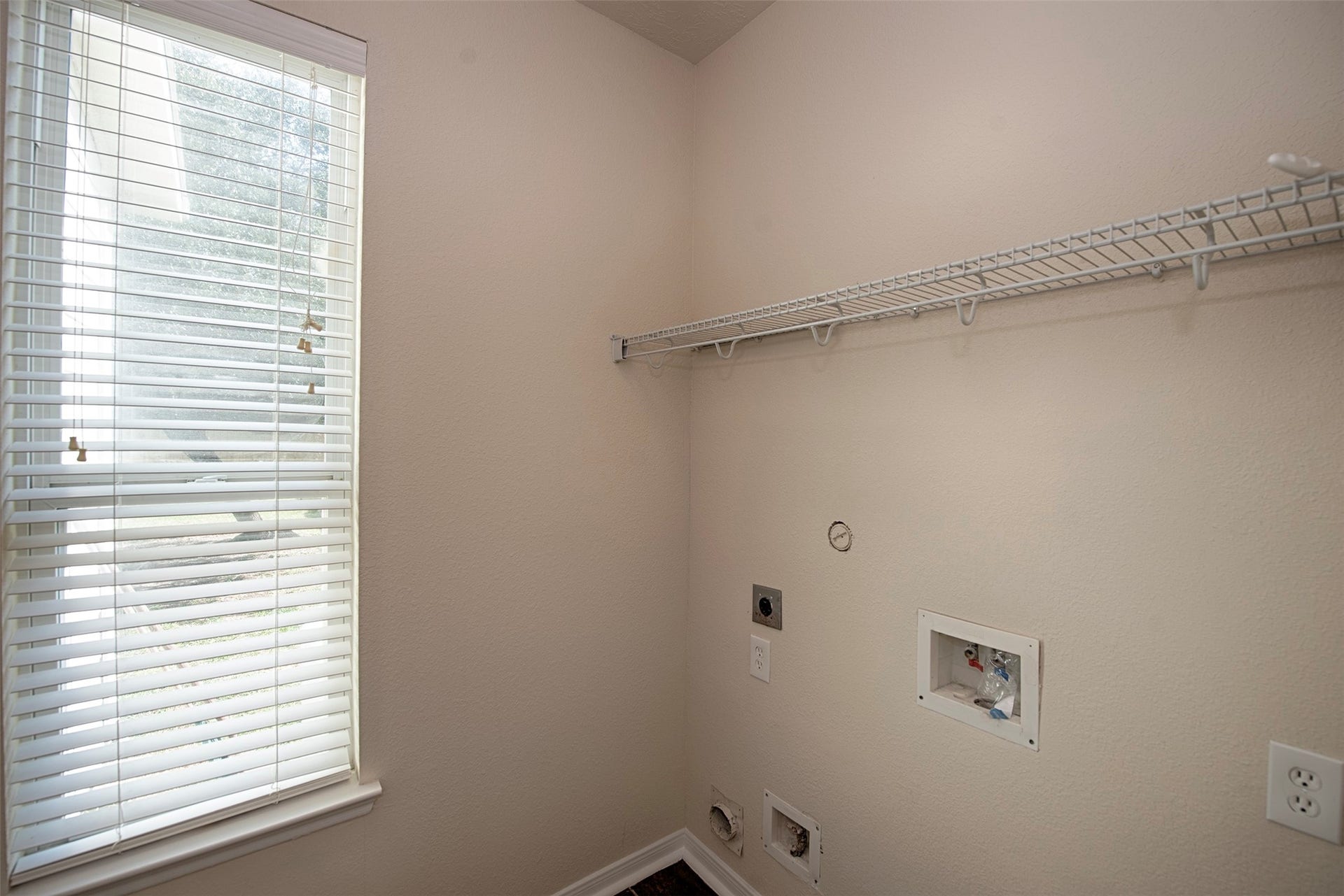 106 Easton Glen Lane, Dickinson, TX 77539 Downstairs is the utility room with space for large front loading washer and dryer. Great shelving for your laundry essentials and area to hang your garments after taking them out of the dryer.