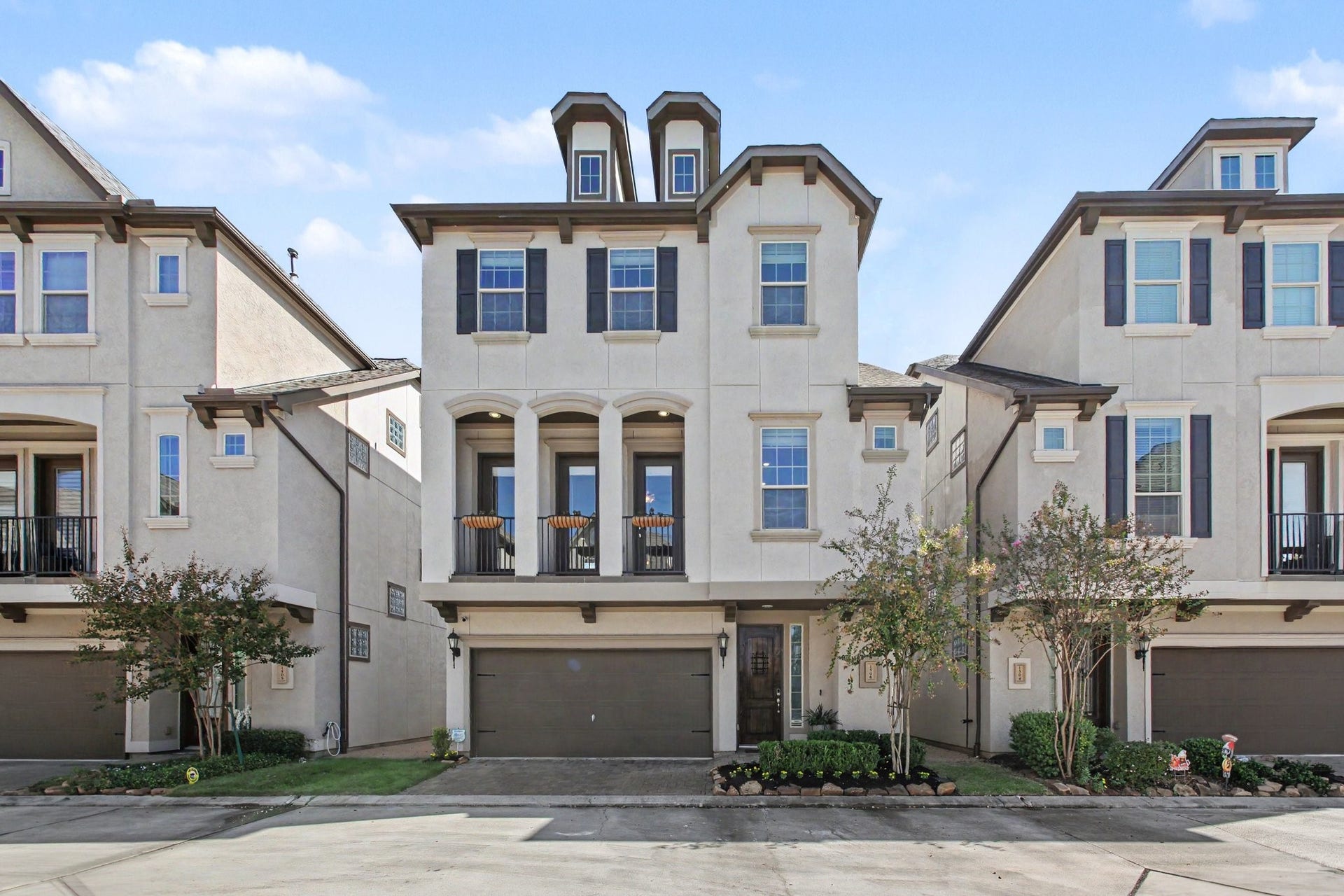 1506 Peyton Oaks Place, Houston, TX 77043 Elegant three-story home featuring a charming covered balcony, attractive architectural details