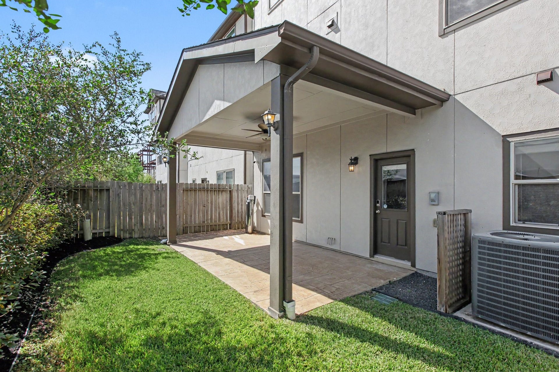 1506 Peyton Oaks Place, Houston, TX 77043 The backyard covered patio with lighting and ceiling fan