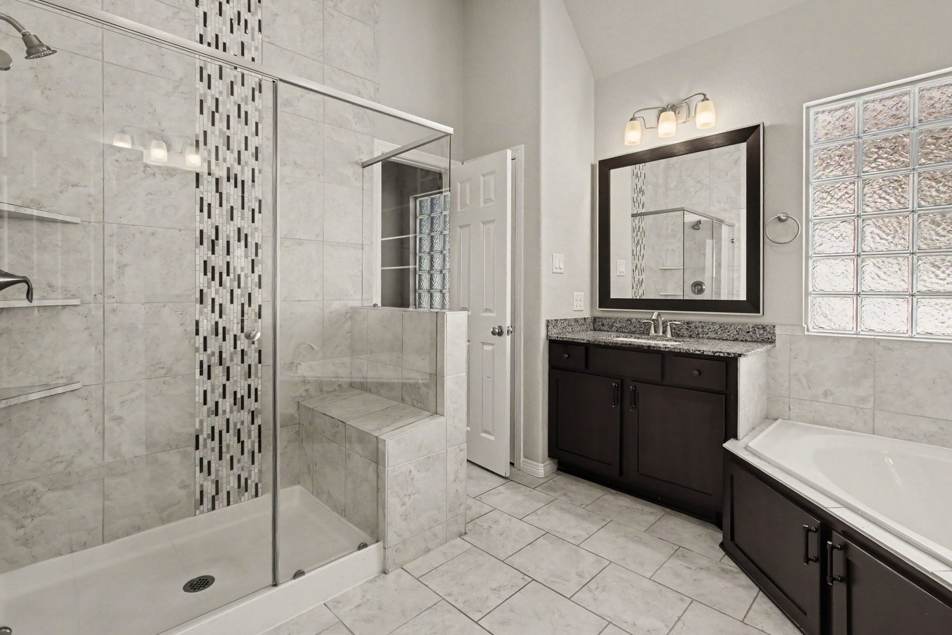 1506 Peyton Oaks Place, Houston, TX 77043 Primary bathroom with double vanities, bathtub and walk-in shower