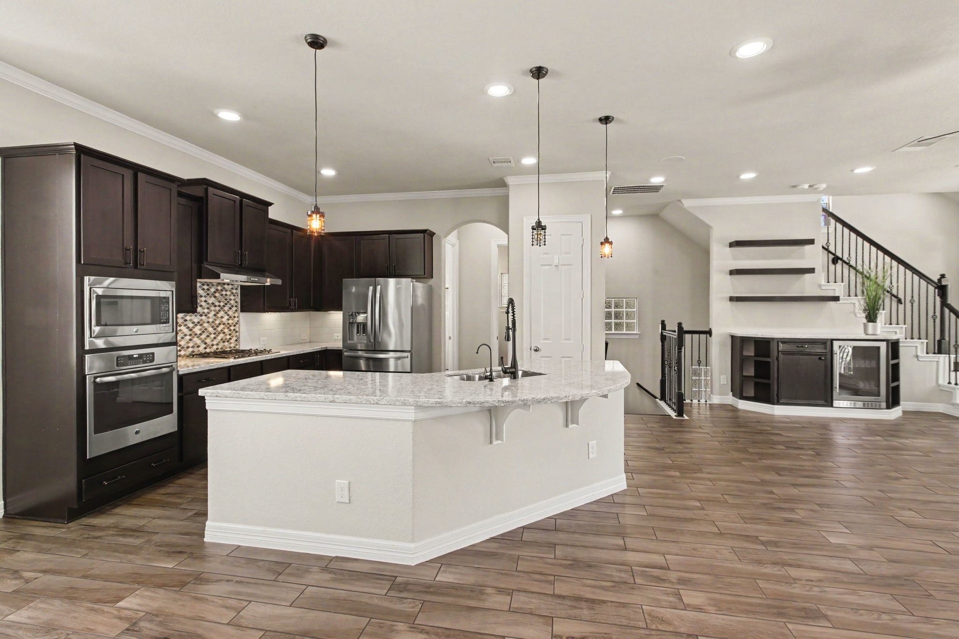 1506 Peyton Oaks Place, Houston, TX 77043 Spacious, open kitchen with large island, granite countertops, and stainless steel appliances