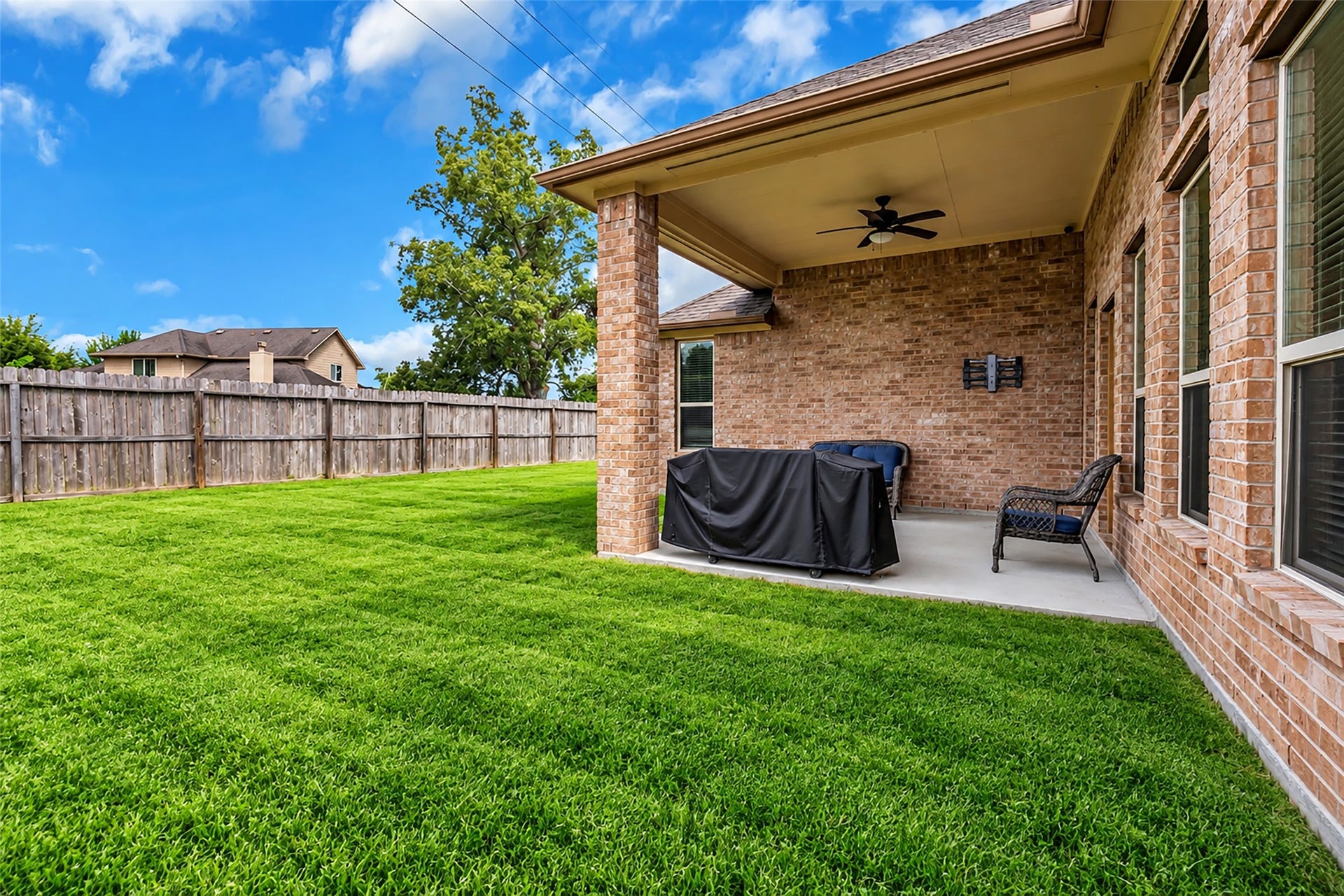 7 Ember Branch Drive, Missouri City, TX 77459 Relax or grill on the covered back patio with a ceiling fan, overlooking the lawn.