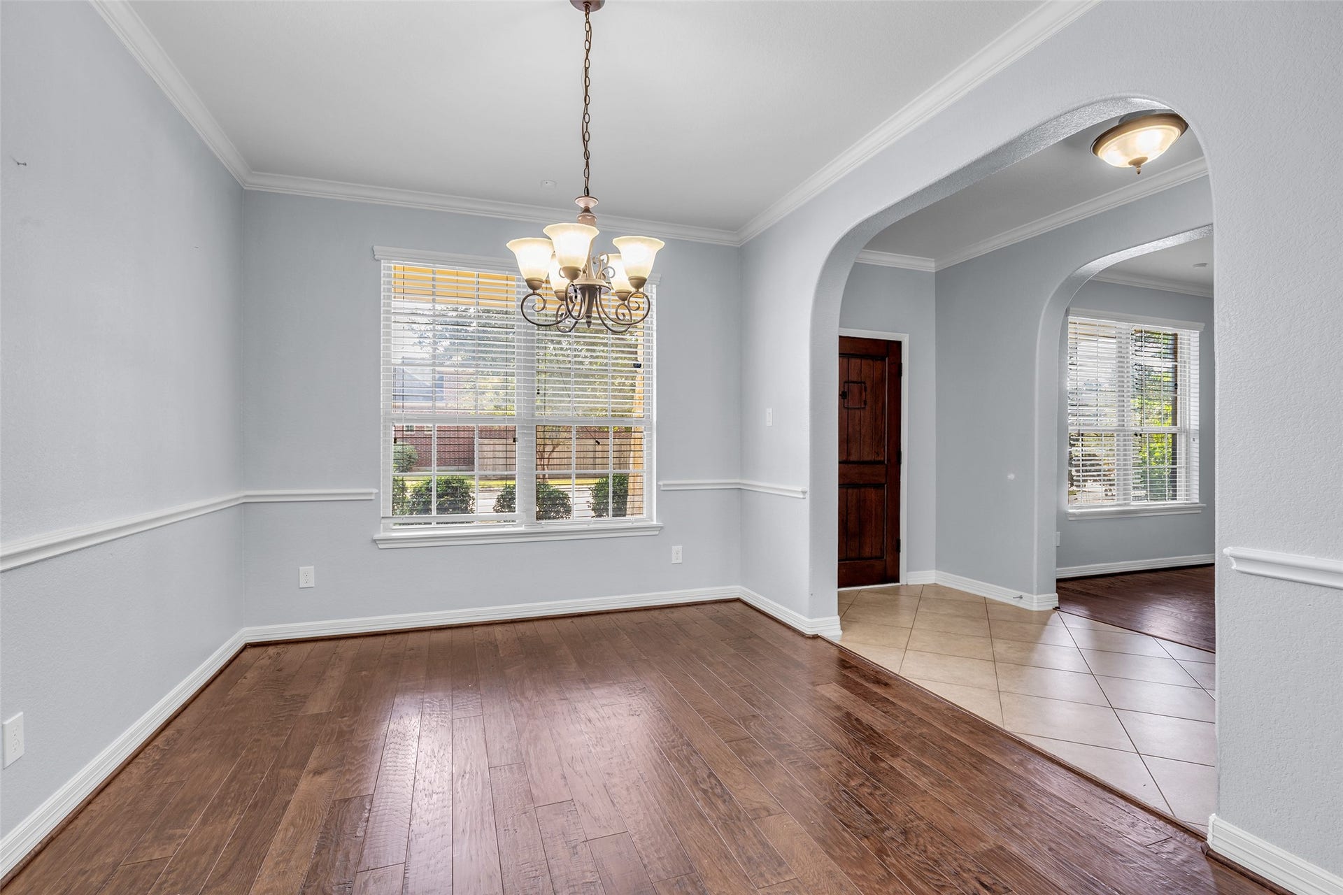 7 Ember Branch Drive, Missouri City, TX 77459 Host dinners in the formal dining room, with wood floors, a chandelier, crown molding and chair rail.