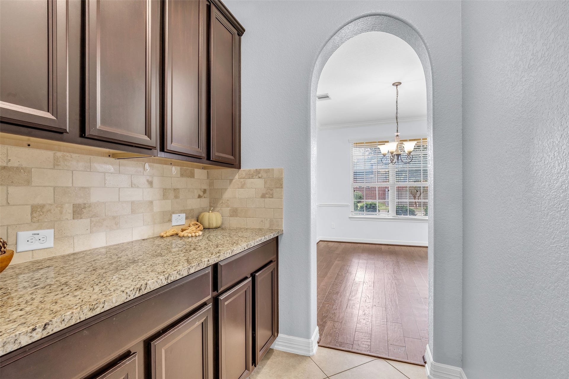 7 Ember Branch Drive, Missouri City, TX 77459 The butler's pantry adds granite counter space and upper cabinets between the kitchen and formal dining, handy for serving and entertaining.