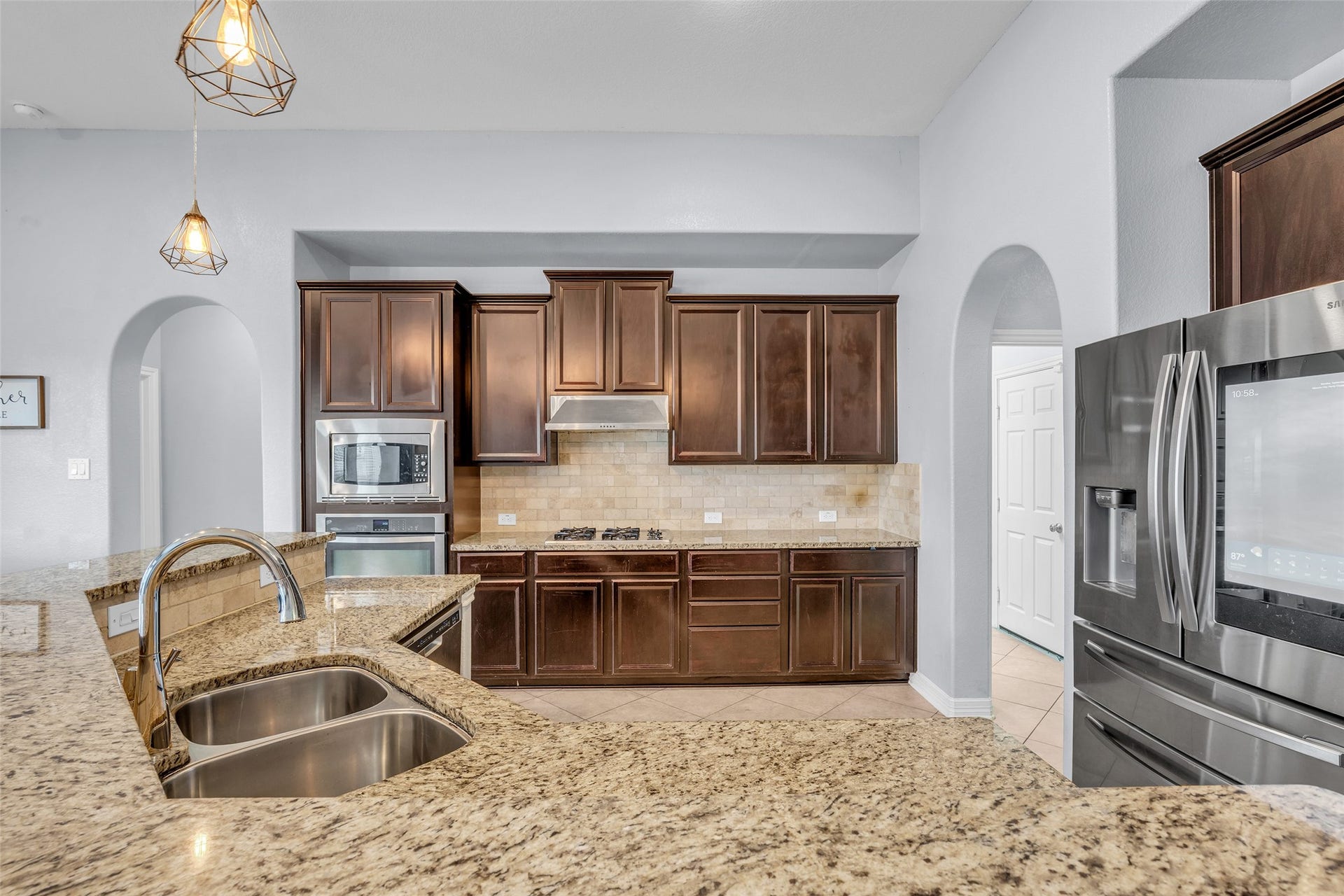 7 Ember Branch Drive, Missouri City, TX 77459 Built-in oven and microwave, a stainless refrigerator and plenty of cabinet storage keep meal prep easy.
