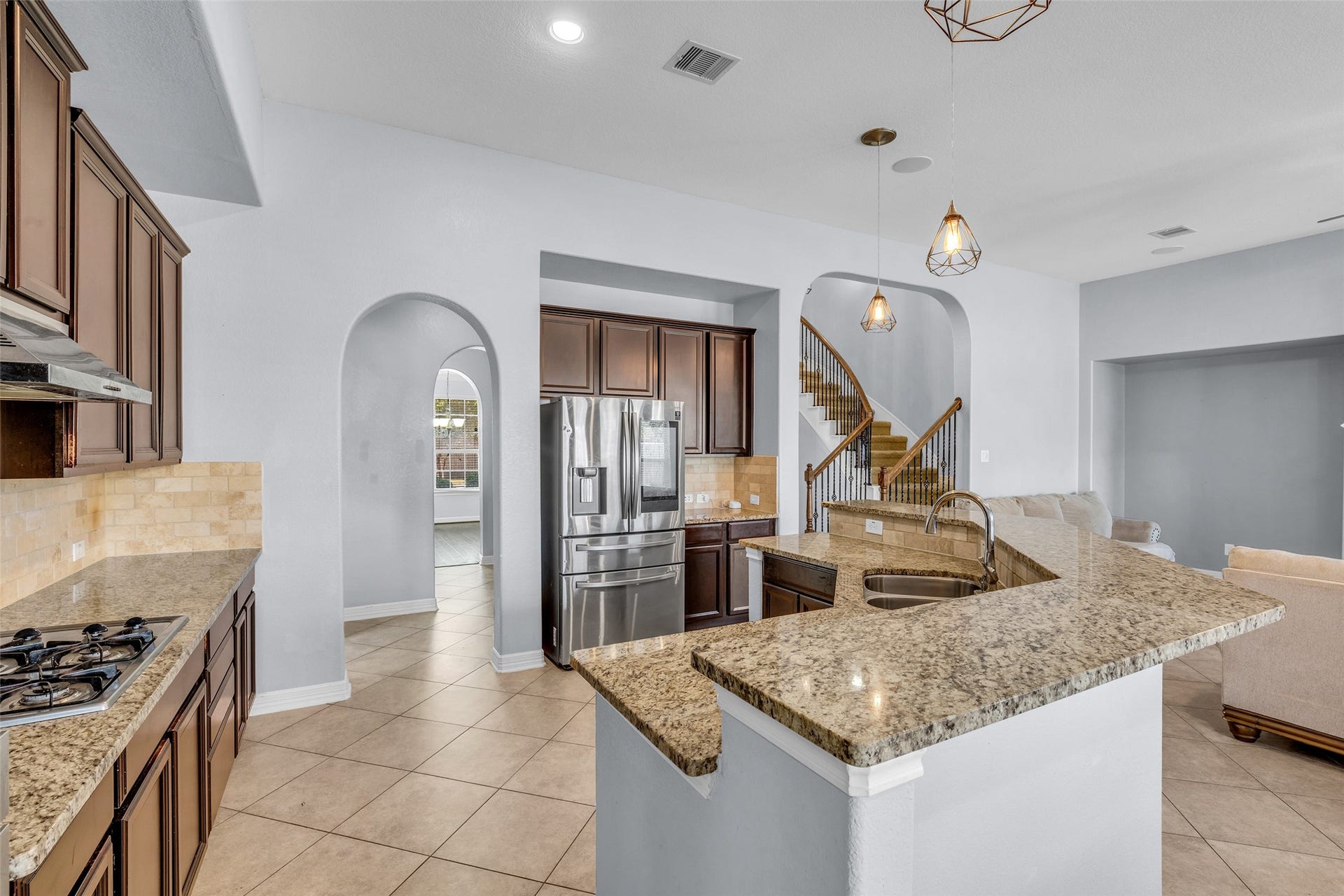 7 Ember Branch Drive, Missouri City, TX 77459 The large granite island with breakfast bar looks out over the living room, so you can cook and chat at the same time.