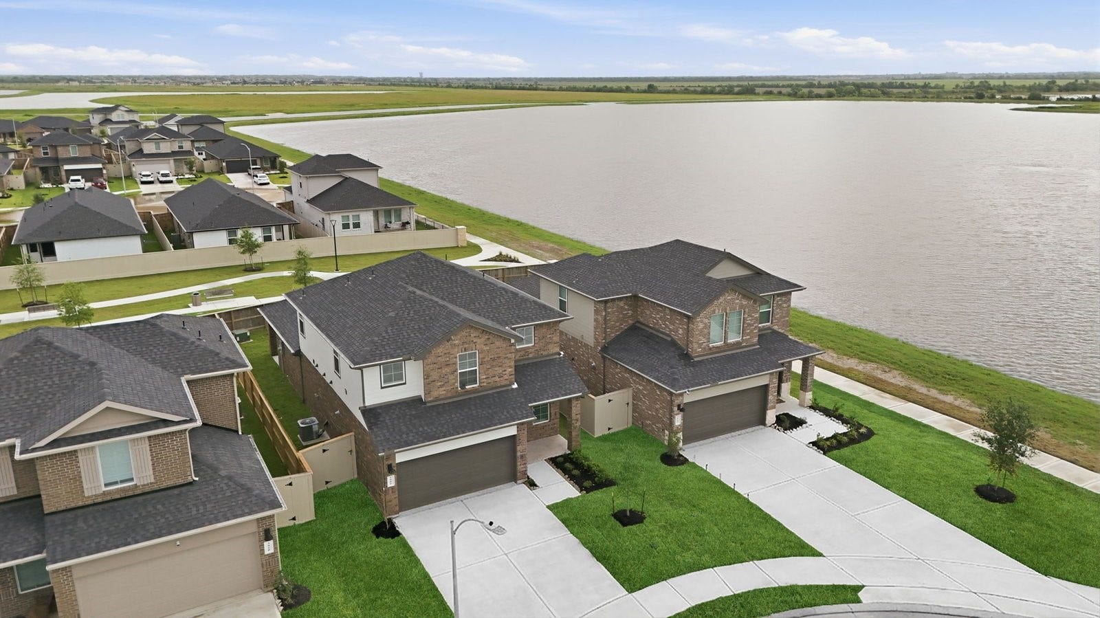3406 Horseshoe Trail Lane, League City, TX 77511 An aerial view of the newly built two story home with traditional architecture, a two car garage and a landscaped front yard