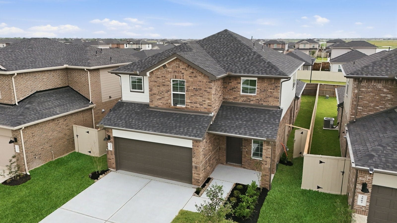 3406 Horseshoe Trail Lane, League City, TX 77511 Newly built two story home with traditional architecture, a double garage, and landscaped front yard.