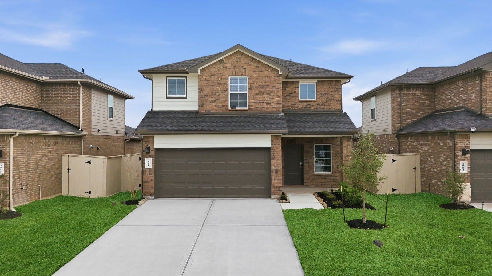 3406 Horseshoe Trail Lane, League City, TX 77511 A two-story home with brick and stone exterior with a two-car garage and a well-maintained front lawn in league city