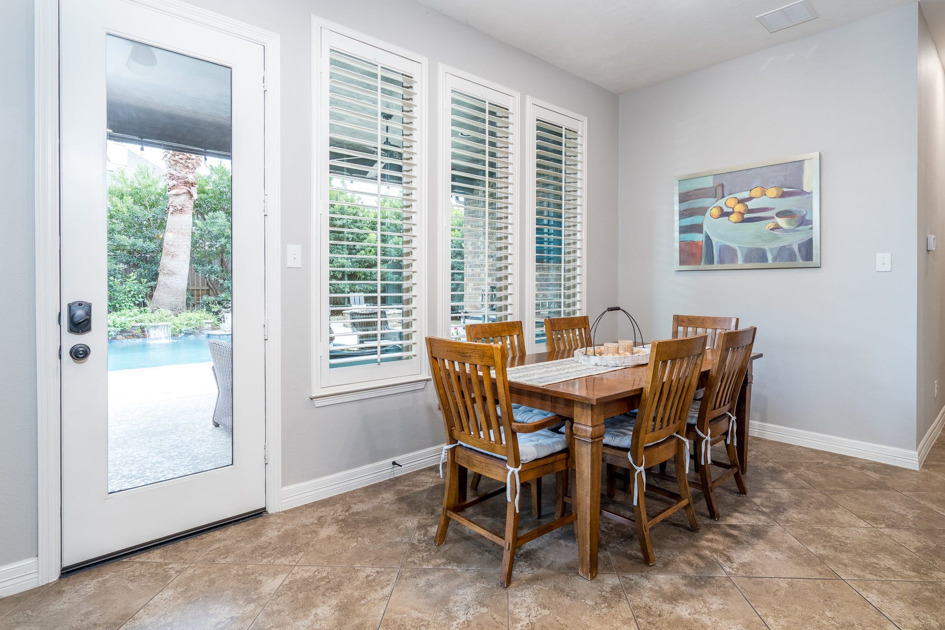 A large breakfast area features plenty of sunlit space for family to gather, plus a glass door leading to your backyard paradise!