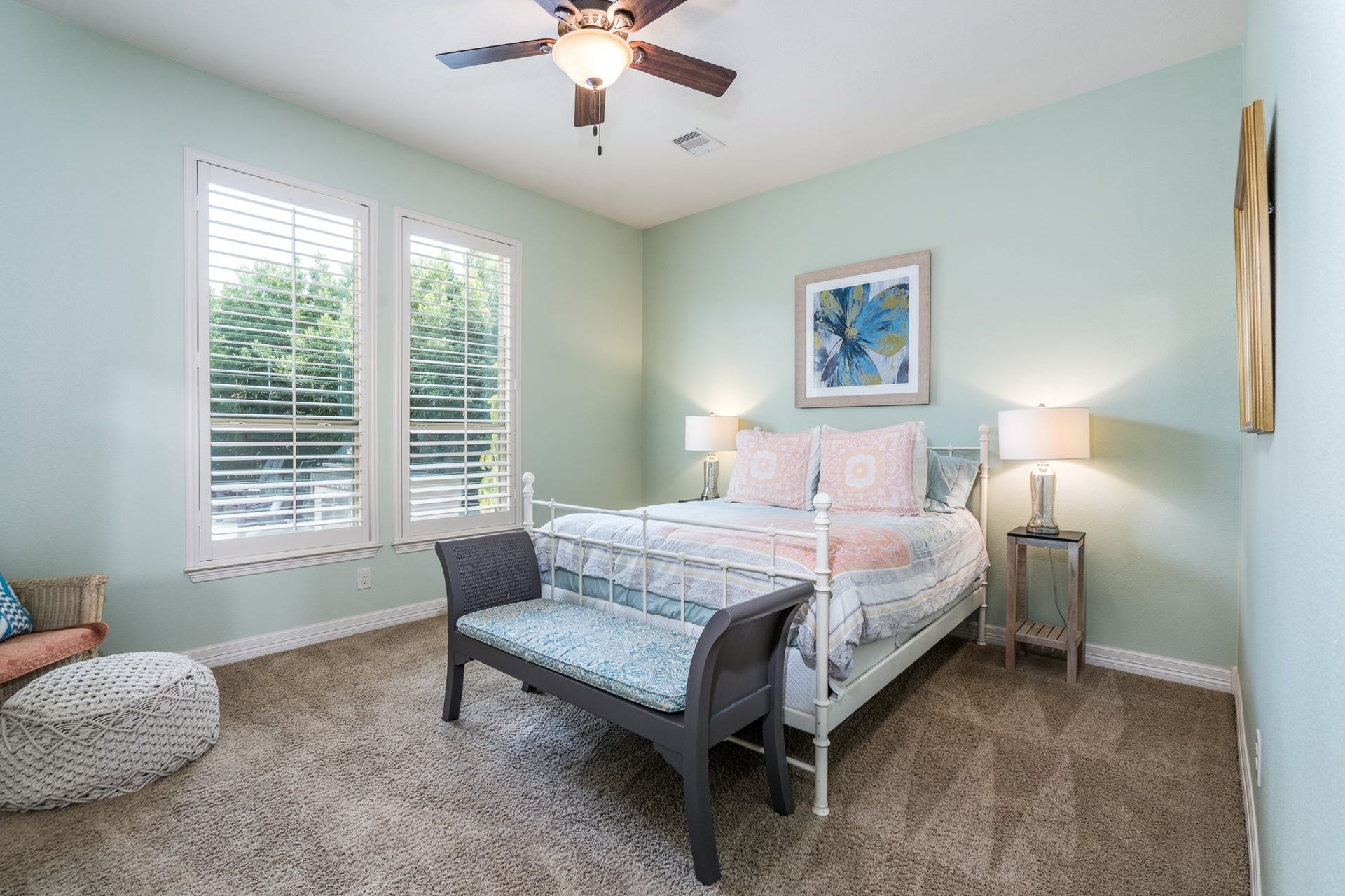 The first of four secondary bedrooms is conveniently located off of the kitchen area on the first floor. With its own private bath, it makes a great mother-in-law suite! This room boasts plantation shutters, huge walk-in closet, ceiling fan and soft, neutral carpet!