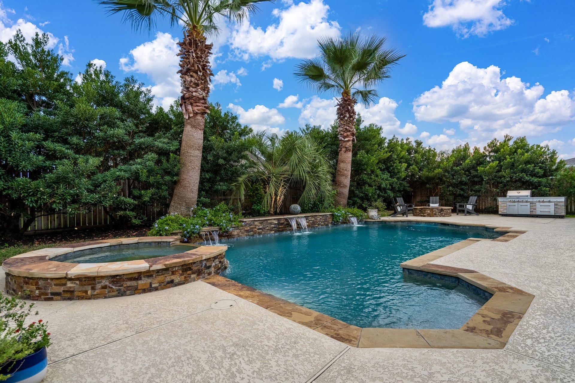 Welcome to your backyard oasis...a sparkling pool, relaxing spa, cozy firepit and outdoor grill! An added bonus is the mature, tropical landscaping that provides enough privacy to truly enjoy your at-home retreat!