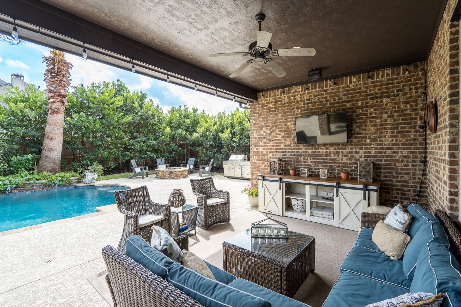 The spacious covered patio with ceiling fan, recessed lighting and surround sound is the ultimate place to gather for an afternoon by the pool!