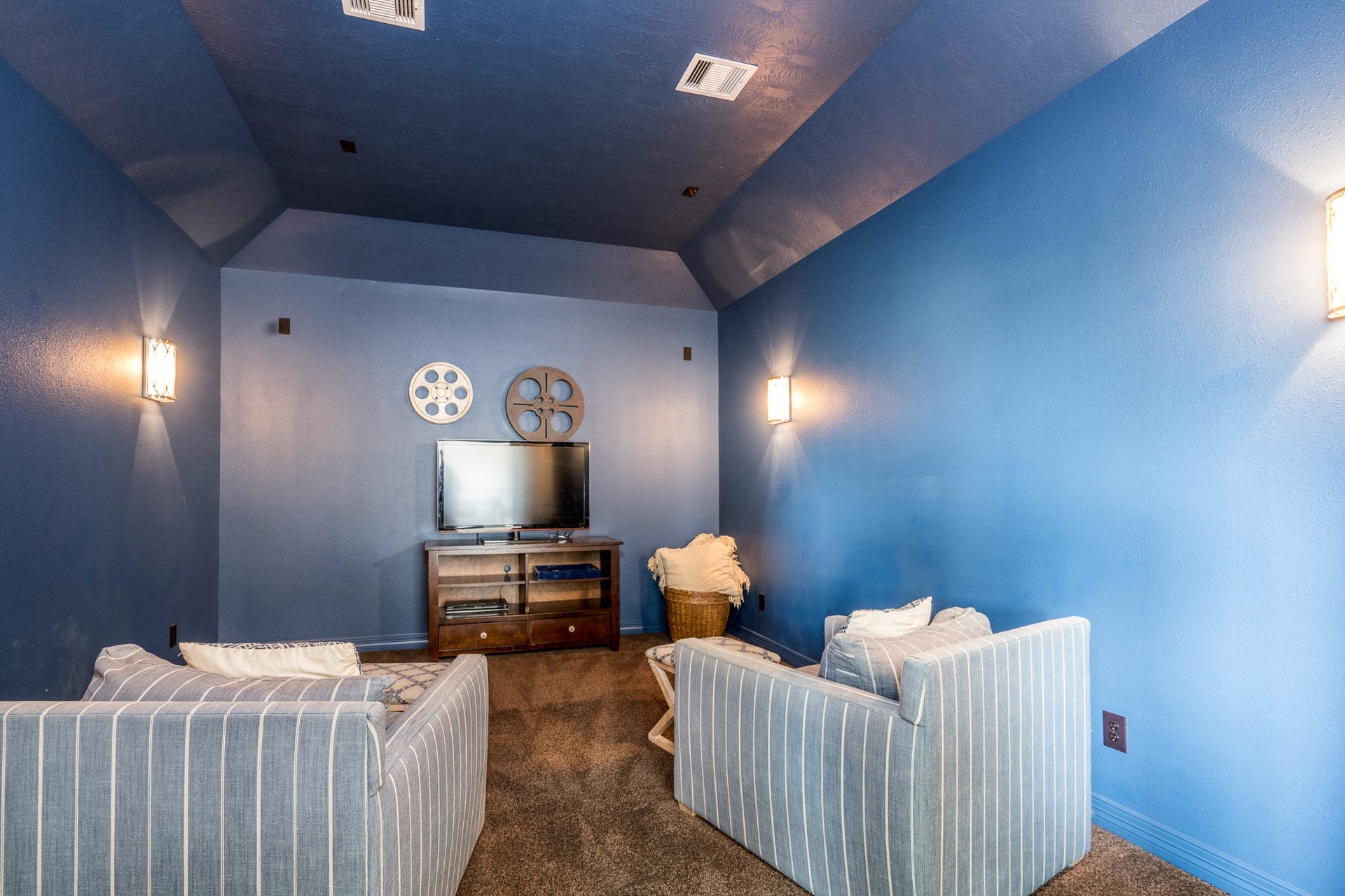 Pass the popcorn! This sleek media room is ready for you to take in the next classic or feature film!