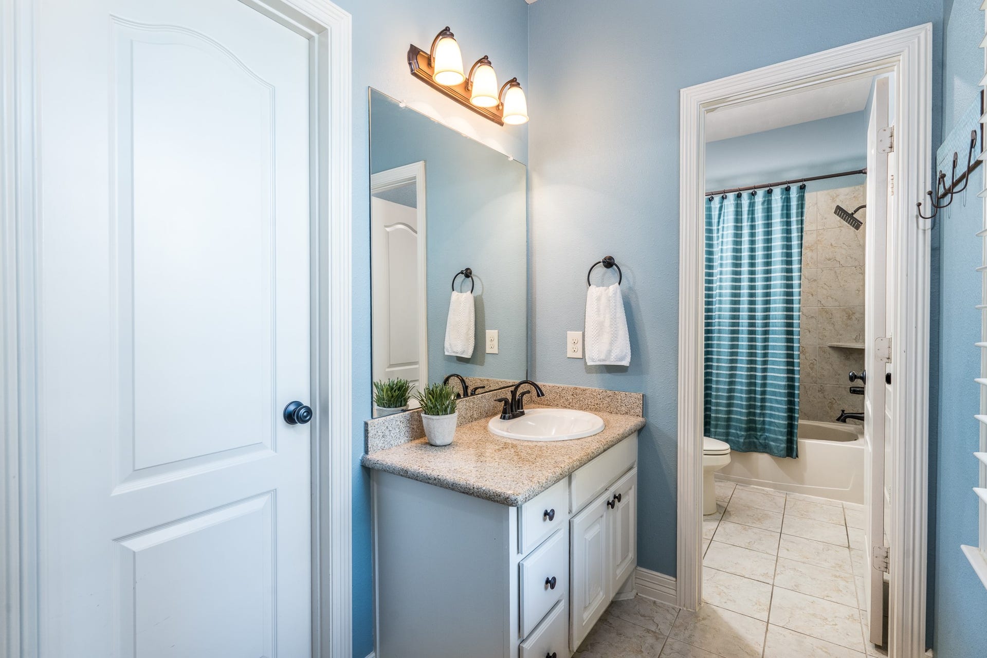 The Jack n Jill bath provides private wet areas plus a shower/tub combo with tile surround...the perfect solution to busy mornings!