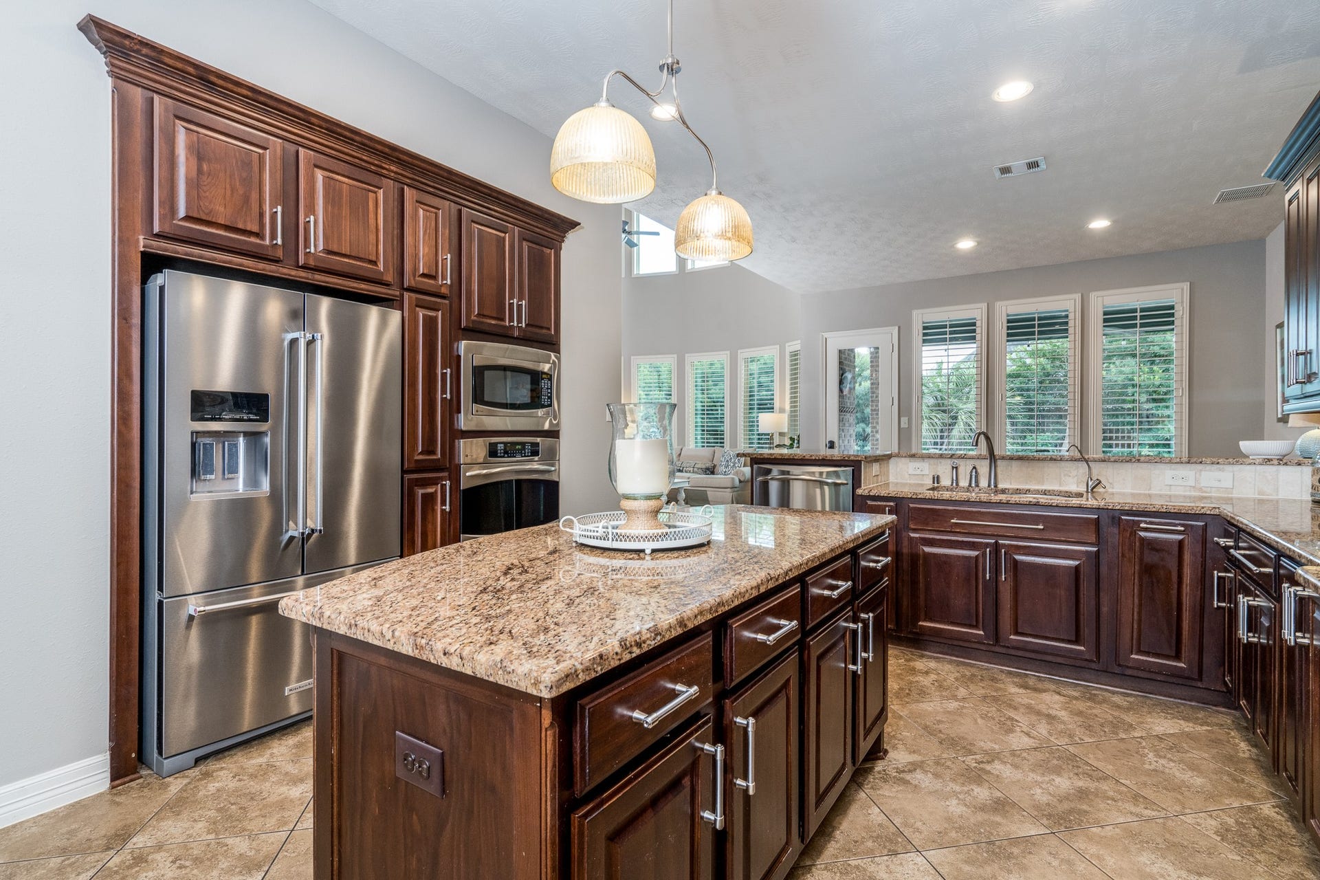 Another view of the expansive kitchen with a multitude of cabinets and drawers that provide ample storage for all of the chef's needs!