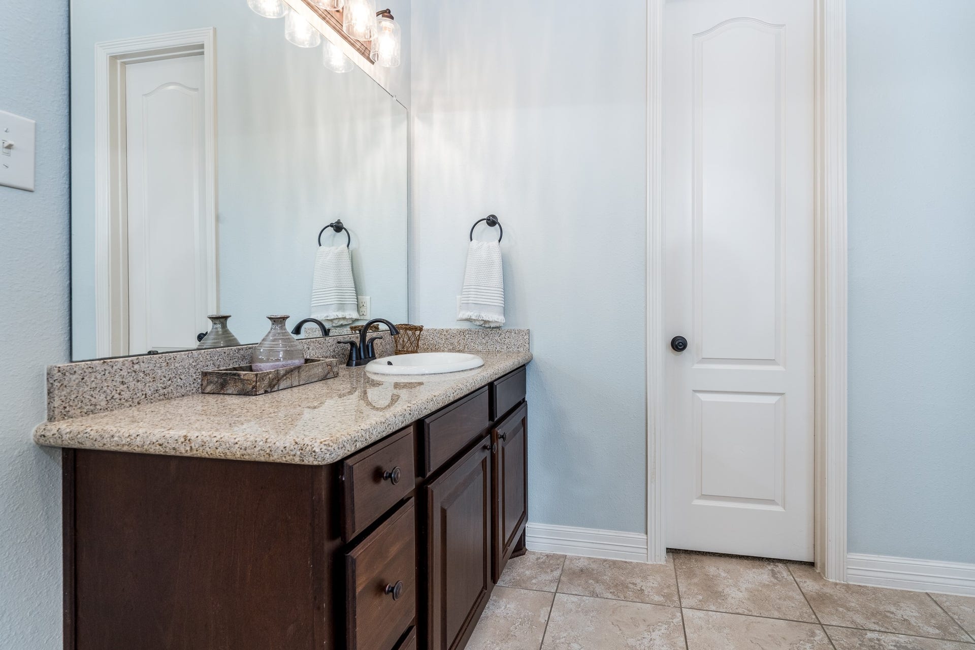 Granite countertops, ceramic tile flooring and antique bronze fixtures complete the look of this show stopper bath!