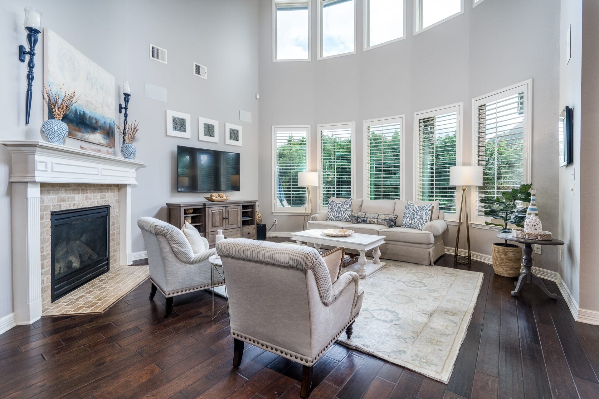 This view of the family room showcases the wall of windows and corner fireplace with slate surround. What a warm yet sophisticated space!
