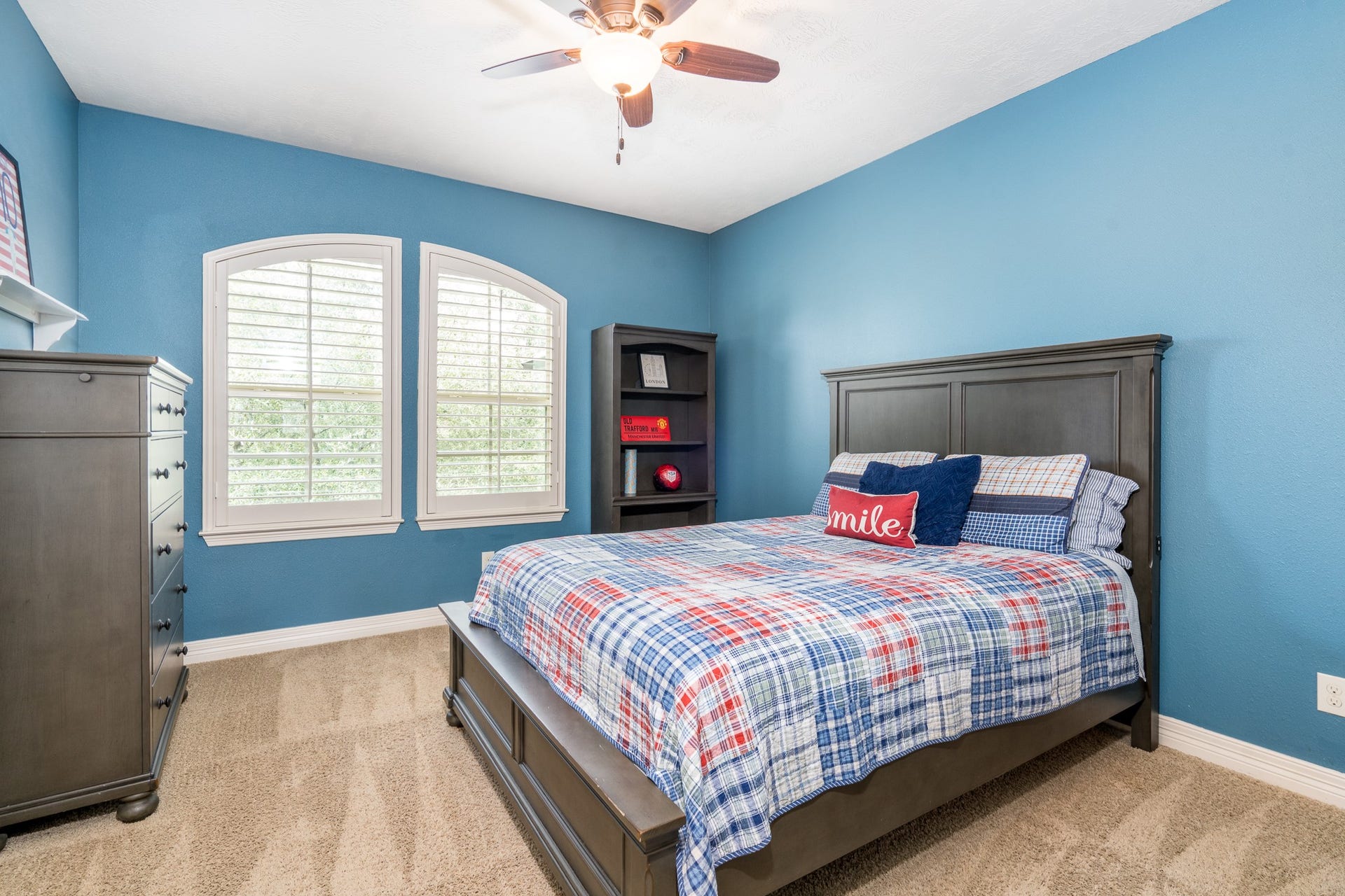 The second of four secondary bedrooms offers soft neutral carpet, plantation shutters, walk-in closet and ceiling fan! This bedroom has its own vanity and connects to the Jack n Jill bath.