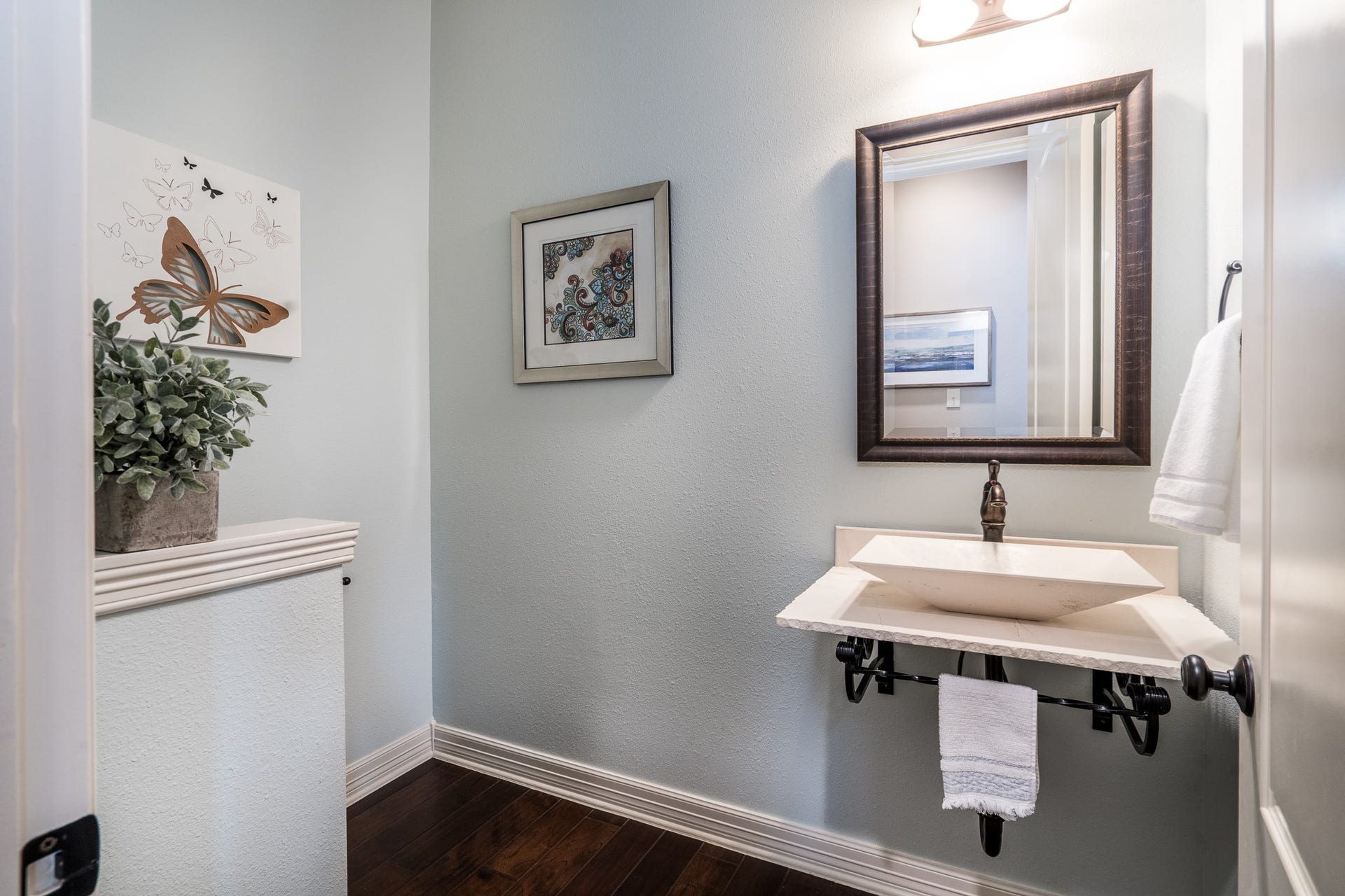 The powder room offers elegant, modern accents and is located off the main entry. It is just the right place for guests to freshen up!