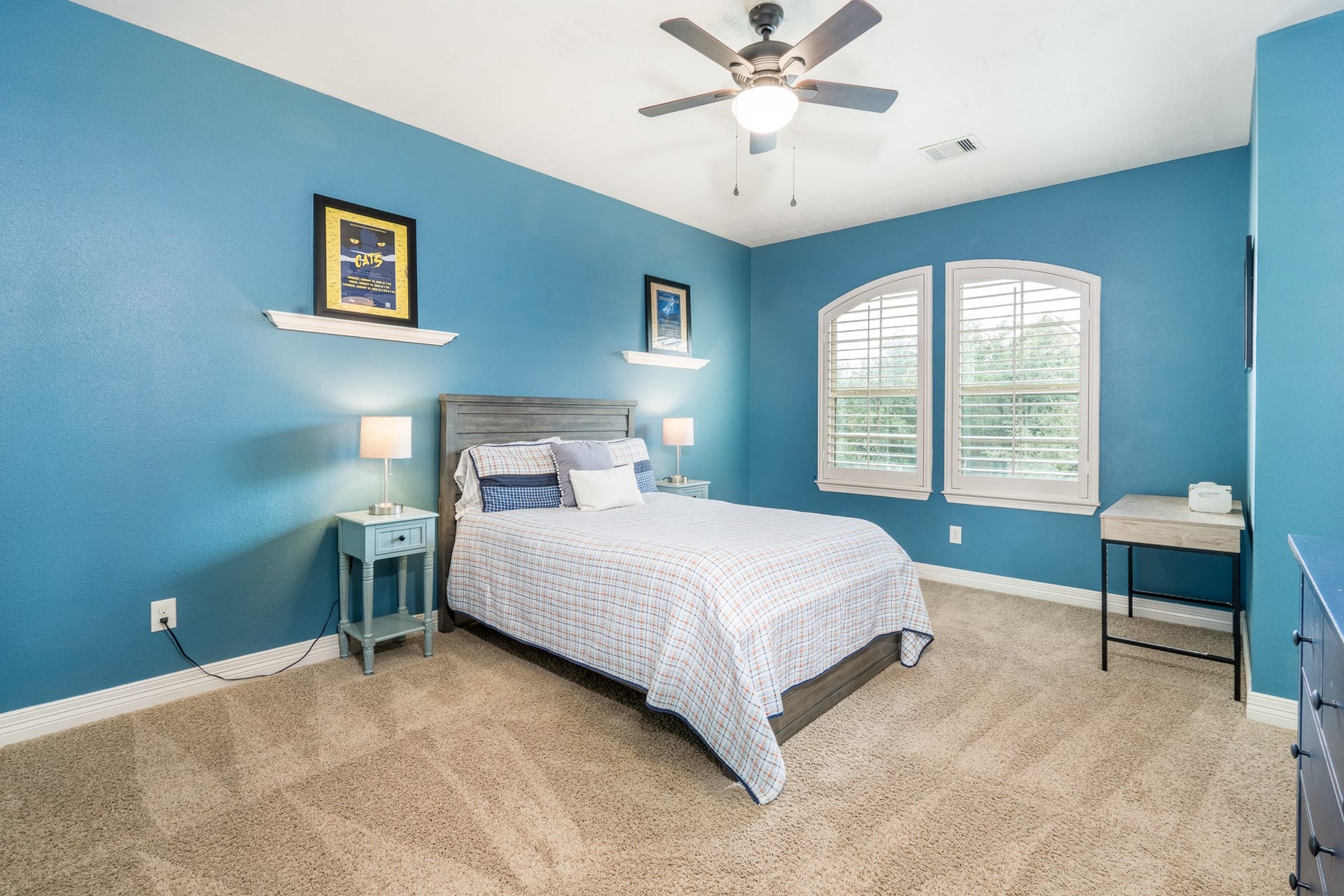 The third of four secondary bedrooms featuring soft, neutral carpet, ceiling fan, plantation shutters and walk-in closet! This bedroom has its own vanity and connects to the Jack n Jill bath.