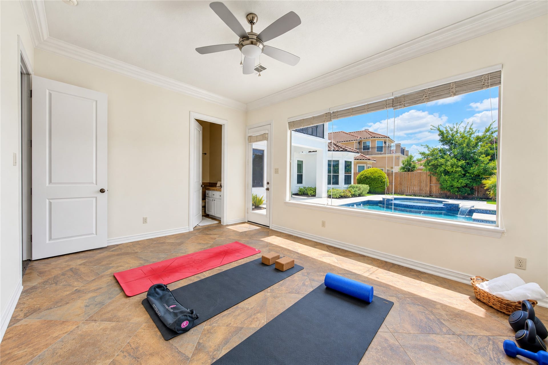 14014 Hampton Cove Drive, Houston, TX 77077 Convenient first-floor bedroom perfect as a guest suite or flexible gym space, complete with easy access to a full bathroom and access to pool and patio.