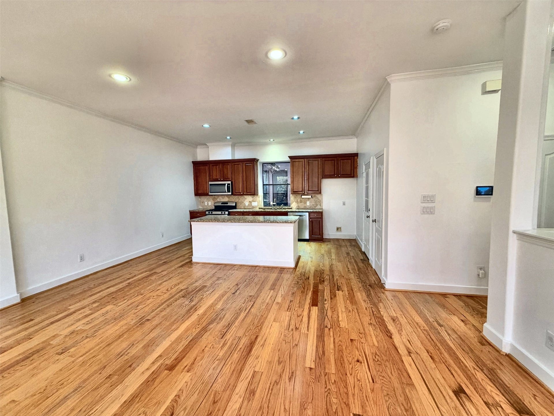2118 Holman Street, Houston, TX 77004 Kitchen offers gas range and a built-in microwave with an island that offers plenty of counter space.