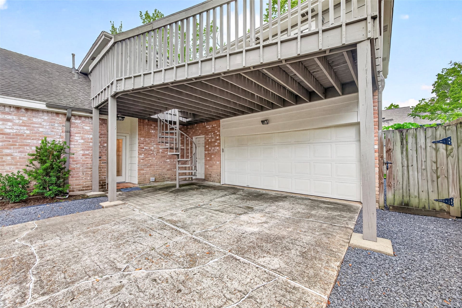 1122 Daria Drive, Houston, TX 77079 Attached garage and covered parking. Notice the circular staircase that takes you to the balcony.
