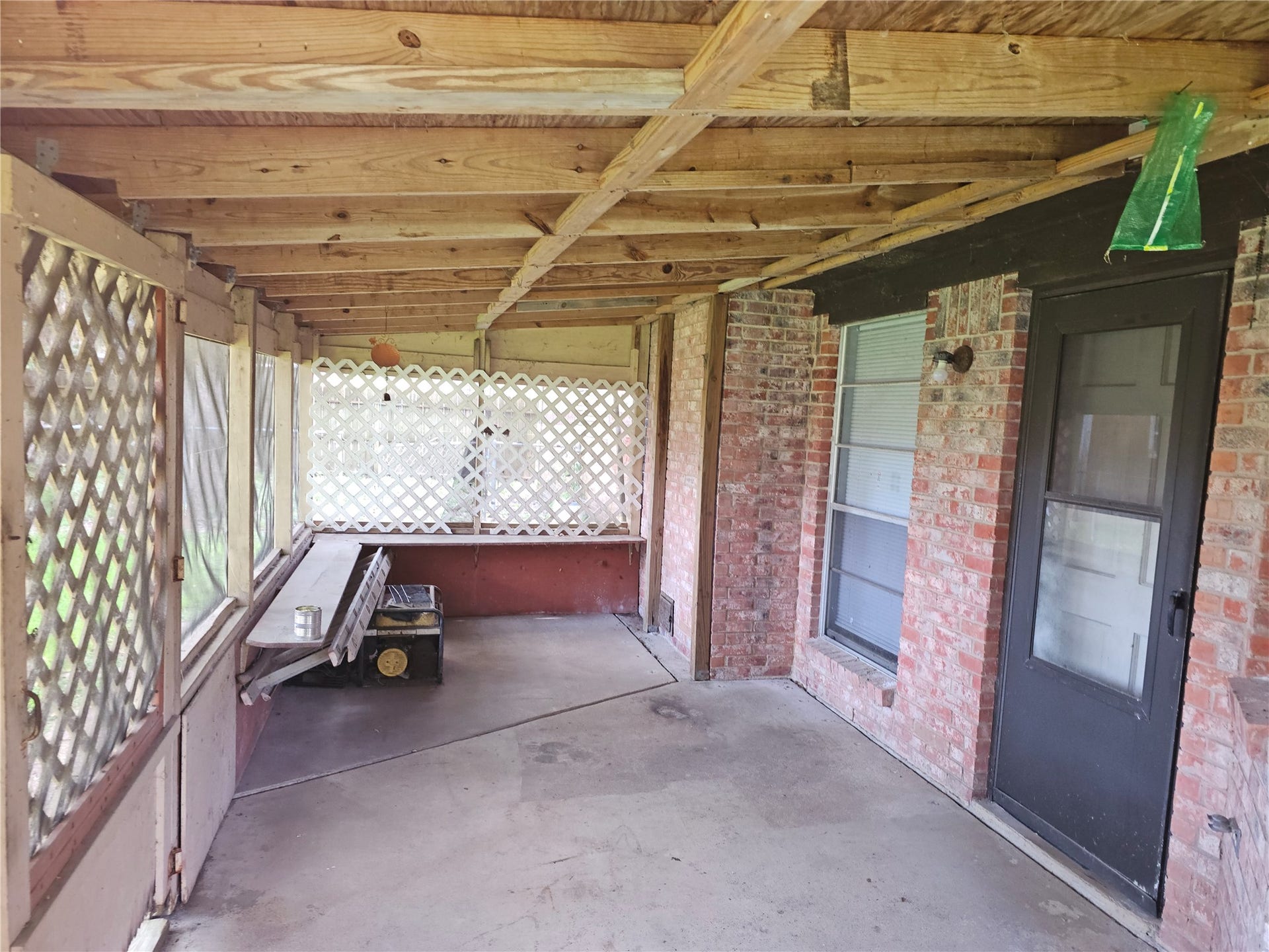 909 Lilac Street, La Marque, TX 77568 Large screened porch provides a shaded retreat for morning coffee, evening gatherings, or simply unwinding outdoors.