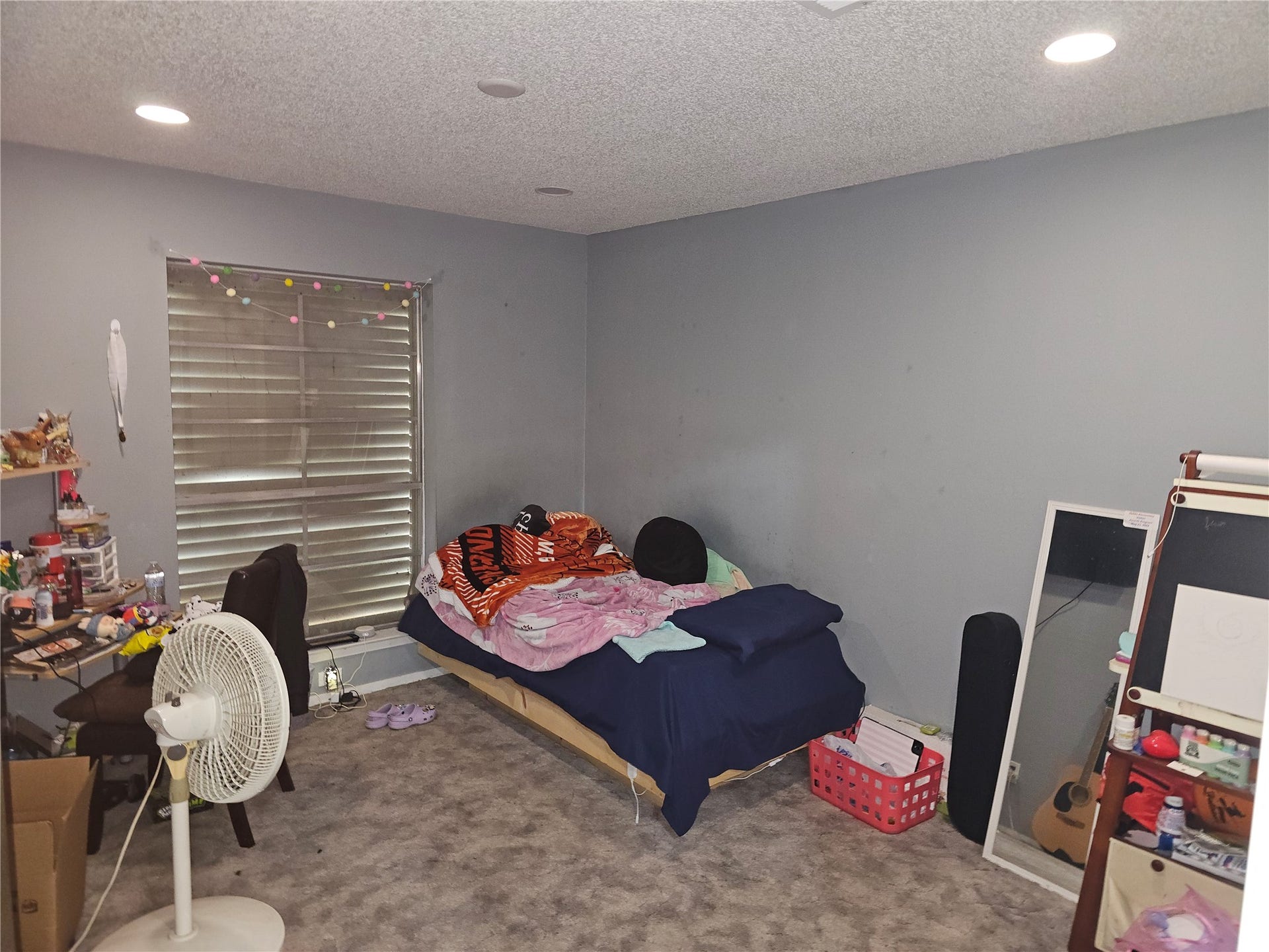 909 Lilac Street, La Marque, TX 77568 Secondary bedroom with plush carpeting, recessed lighting, and a large window for natural light.