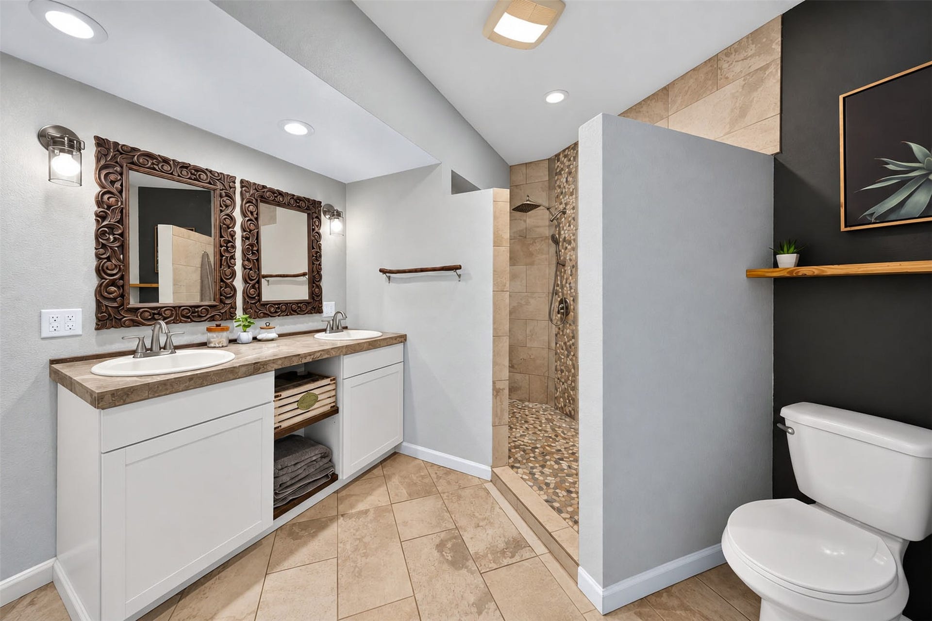 Bathroom features a double-sink vanity, decorative framed mirrors, and a tiled walk-in shower.