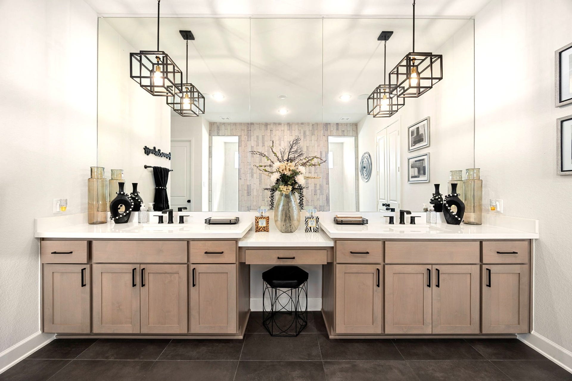 3026 Emerald Field Lane, Fulshear, TX 77423 A custom vanity area showcases premium quartz countertops, thoughtfully designed drawers and cabinets for storage, and upgraded black faucets and pendant lighting that add a bold, contemporary contrast to the luxurious finishes.