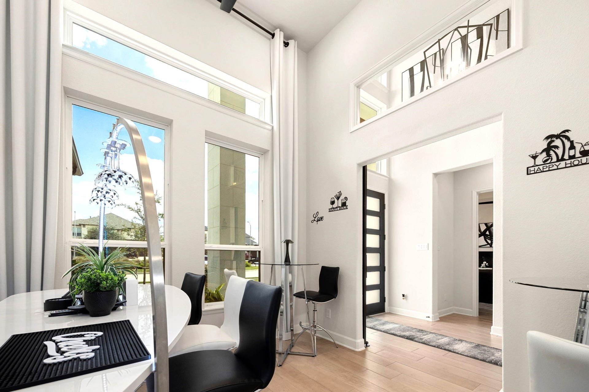 3026 Emerald Field Lane, Fulshear, TX 77423 A sophisticated front-facing private office features soaring ceilings, striking vertical and horizontal windows that invite natural light, and a custom sliding barn door, creating an elegant and functional workspace with added privacy.