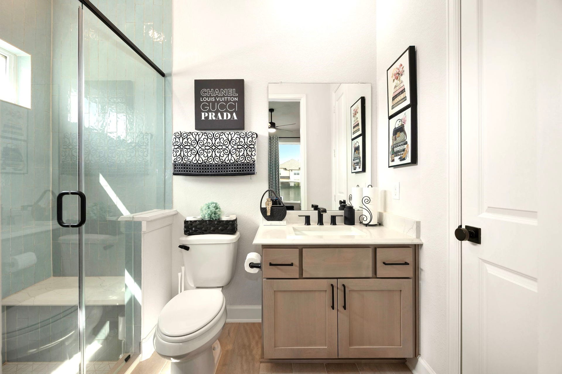 3026 Emerald Field Lane, Fulshear, TX 77423 The private guest ensuite features a spacious walk-in shower with a built-in bench and a dedicated closet, creating a comfortable, thoughtfully designed retreat for guests or extended family.