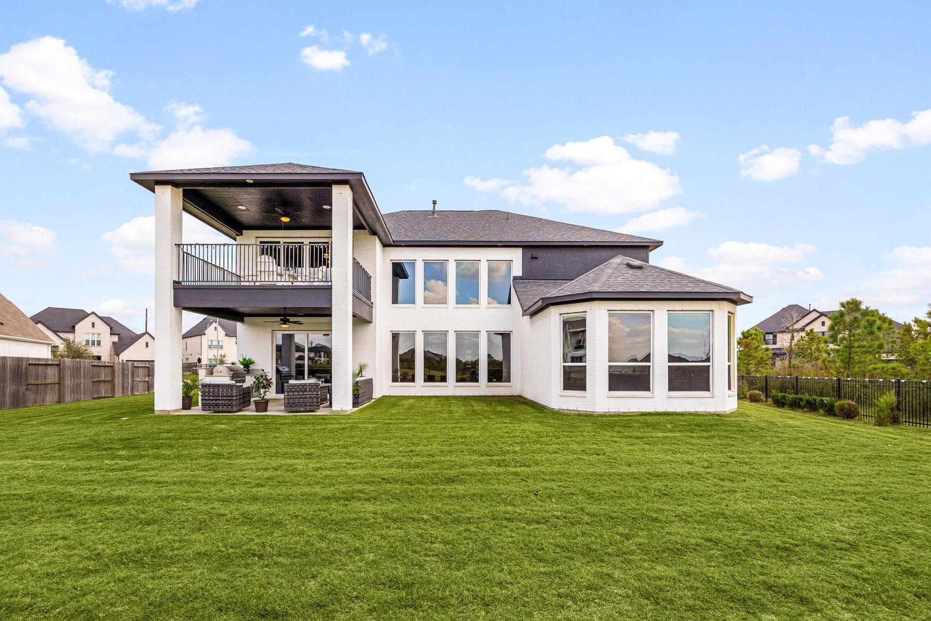 3026 Emerald Field Lane, Fulshear, TX 77423 A stunning waterfront perspective showcasing expansive backyard space, elegant first- and second-floor patios, and generous side-yard spaceall designed to embrace outdoor living, serene lake views, and exceptional entertaining.