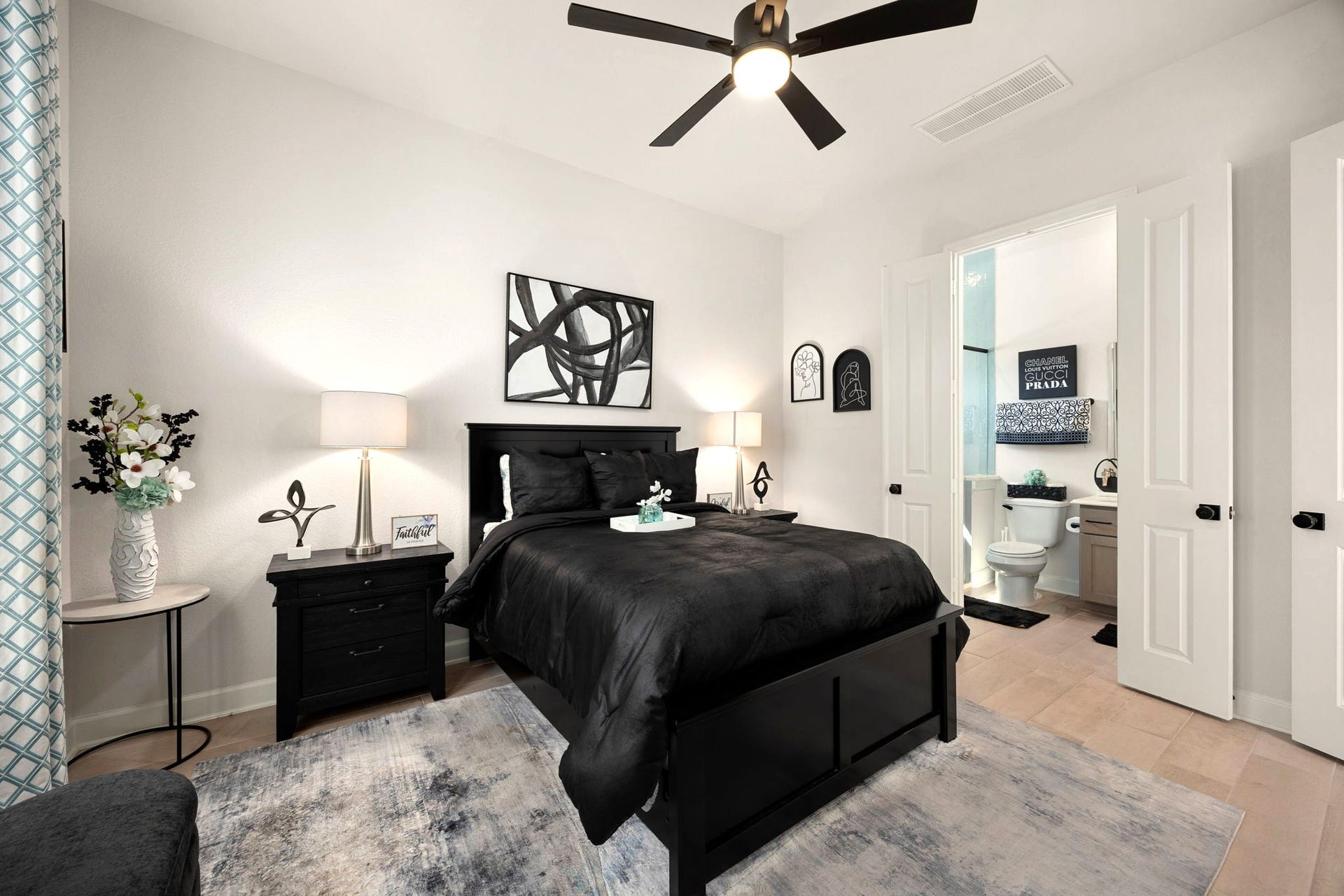 3026 Emerald Field Lane, Fulshear, TX 77423 A private downstairs guest suite features elegant double doors leading to its own ensuite bathroom and dedicated closet, offering exceptional comfort, privacy, and convenience for overnight guests or multigenerational living.