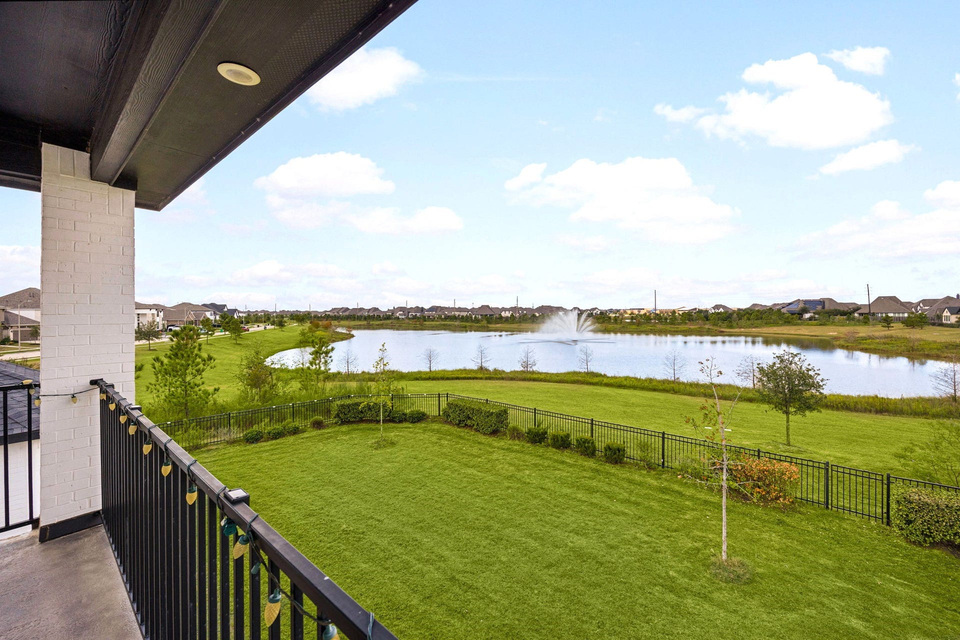 3026 Emerald Field Lane, Fulshear, TX 77423 Enjoy breathtaking lake views from the second-floor covered balcony, an elevated outdoor retreat perfect for morning coffee, sunset relaxation, and sophisticated entertaining against a serene waterfront backdrop.