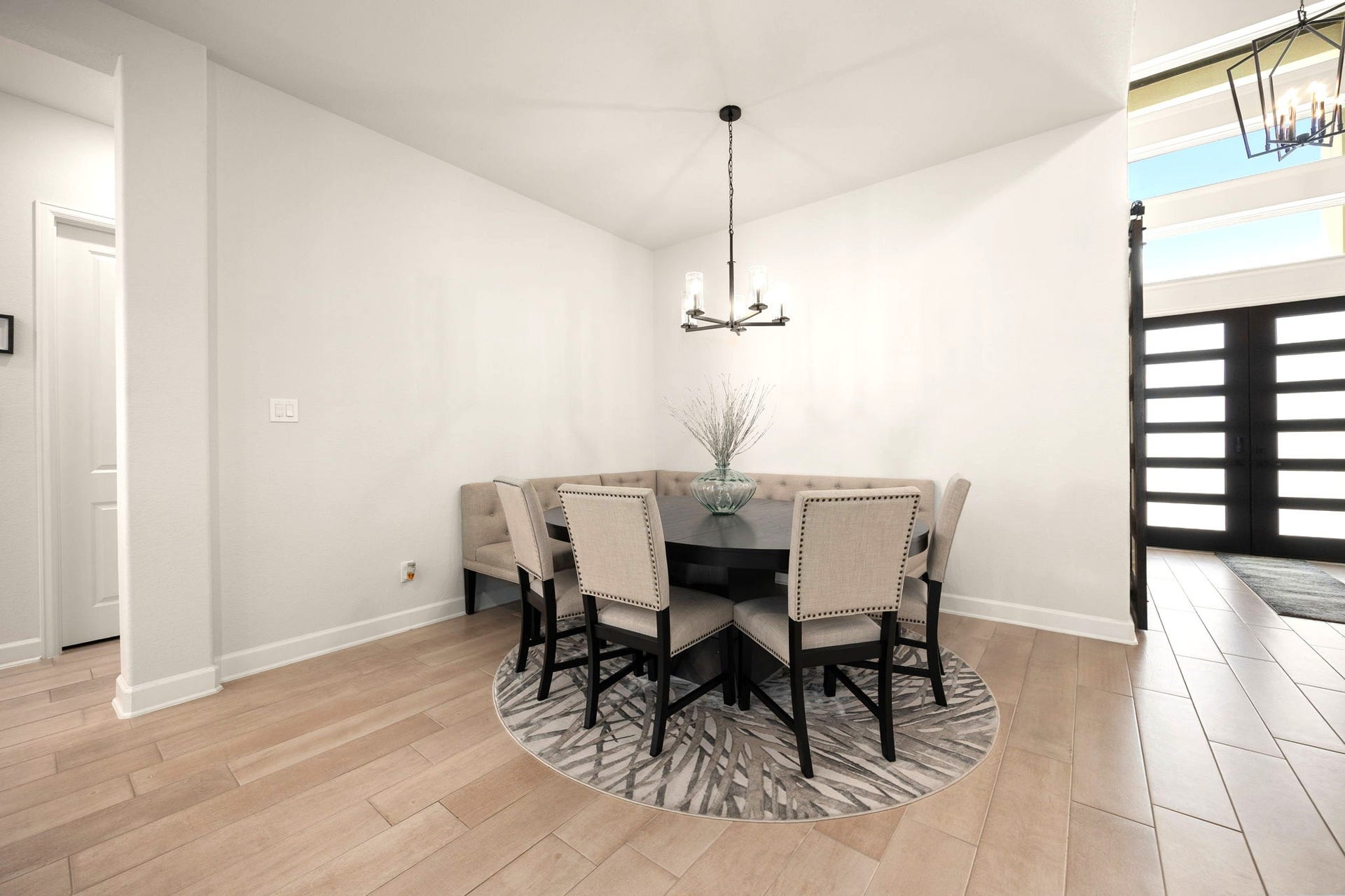 3026 Emerald Field Lane, Fulshear, TX 77423 An elegant formal dining space seamlessly flows into the open-concept living room and upgraded kitchen, creating a sophisticated yet inviting setting for hosting memorable dinners, entertaining guests, and enjoying everyday luxury.