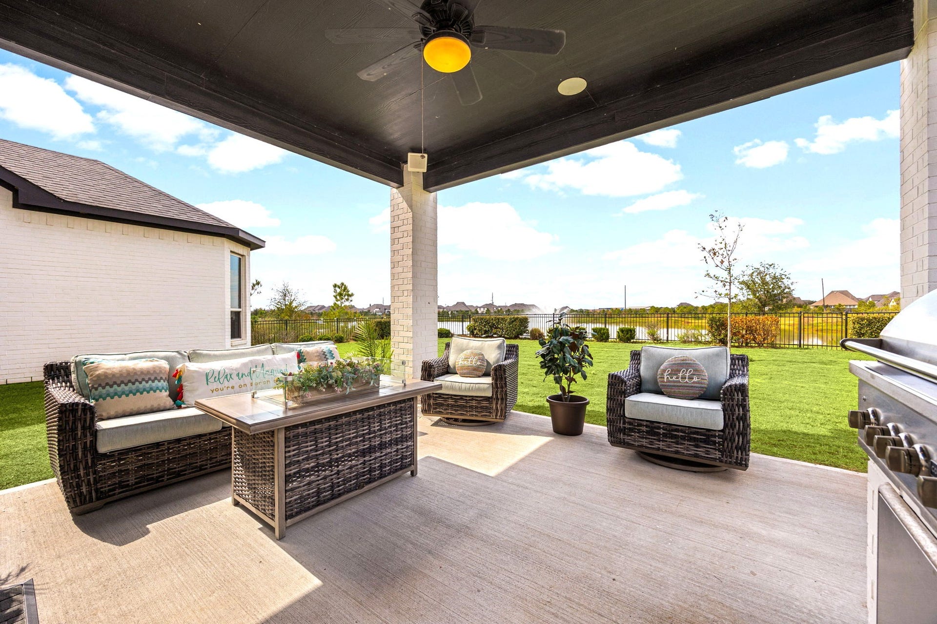 3026 Emerald Field Lane, Fulshear, TX 77423 Enjoy peaceful lake views from the covered patio, enhanced by integrated surround sound speakers that create the perfect atmosphere for outdoor entertaining, relaxing evenings, and luxurious lakeside living.