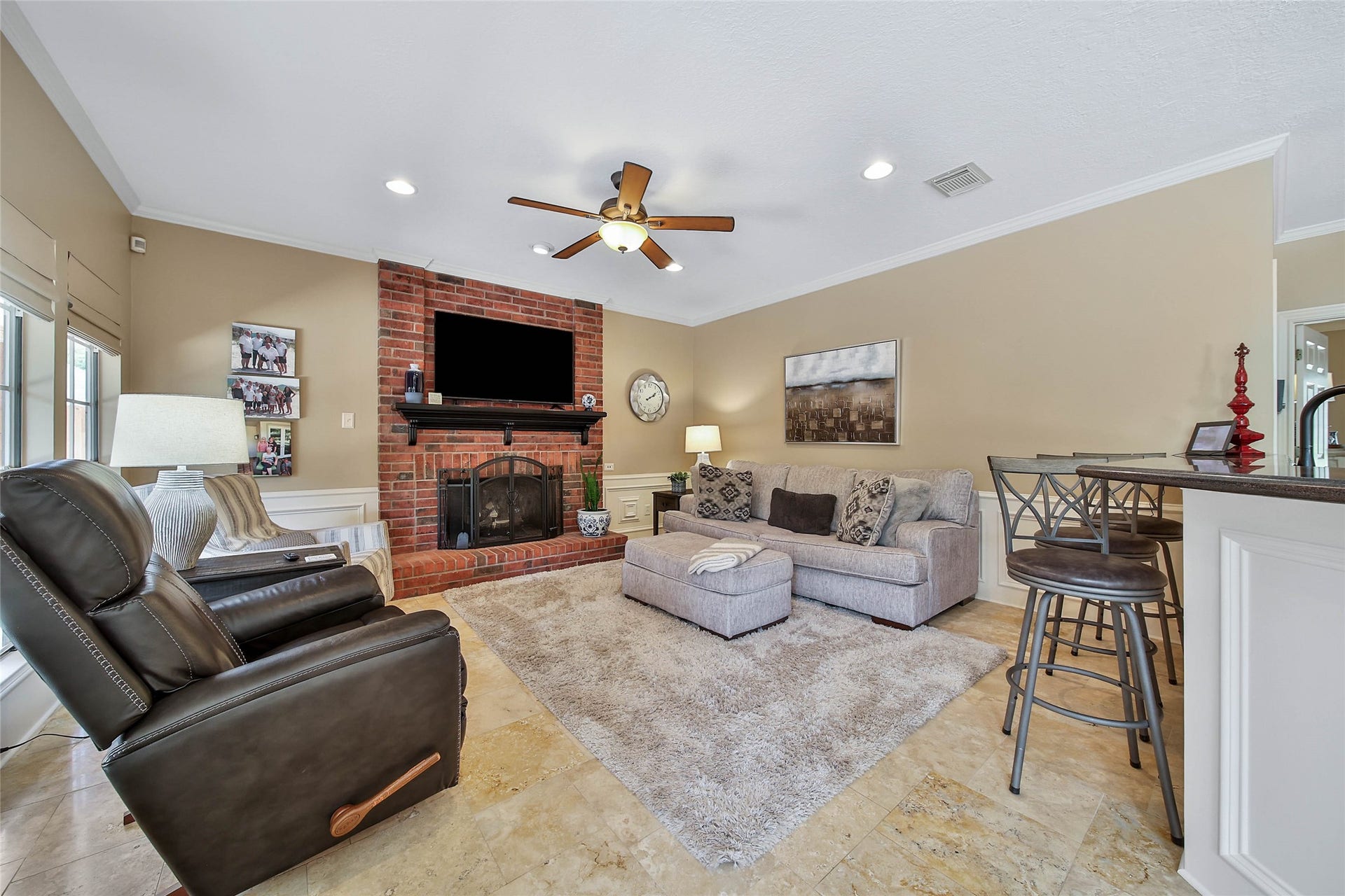 Comfortable family room with brick fireplace located directly off the kitchen and breakfast area.