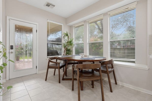 1211 Ragsdale Lane, Katy, TX 77494 Bright and inviting dining area surrounded by large windows that offer ample natural light and a view of the outdoors.