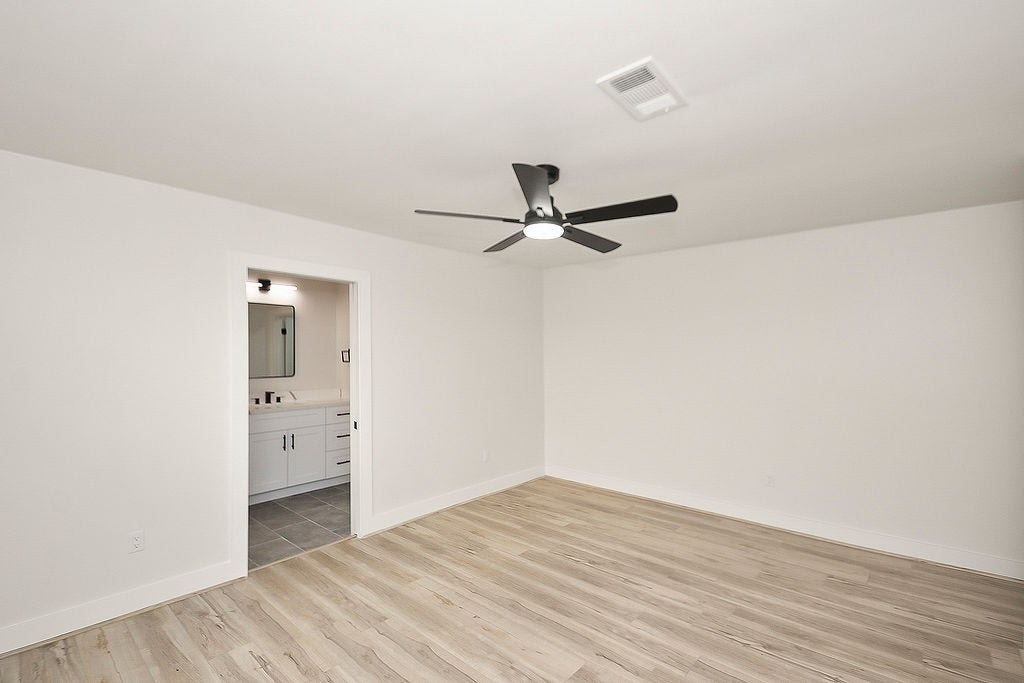 6106 Rutherglenn Drive, Houston, TX 77096 Additional view of the secondary bedroom with modern finishes, updated flooring, and abundant natural light.