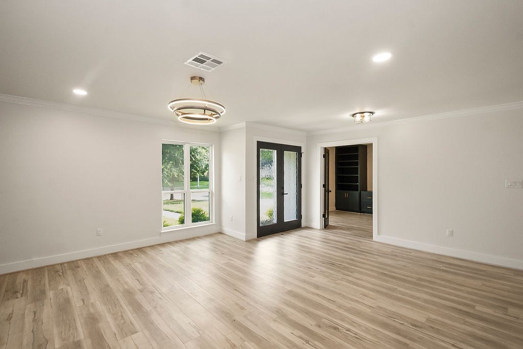 6106 Rutherglenn Drive, Houston, TX 77096 Open-concept dining and gathering area with modern lighting and seamless indoor-outdoor flow.