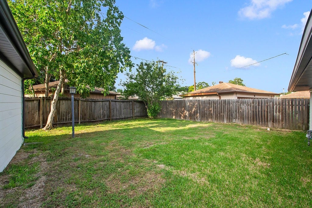 6106 Rutherglenn Drive, Houston, TX 77096 Additional backyard view showcasing the oversized lot and private outdoor retreat.