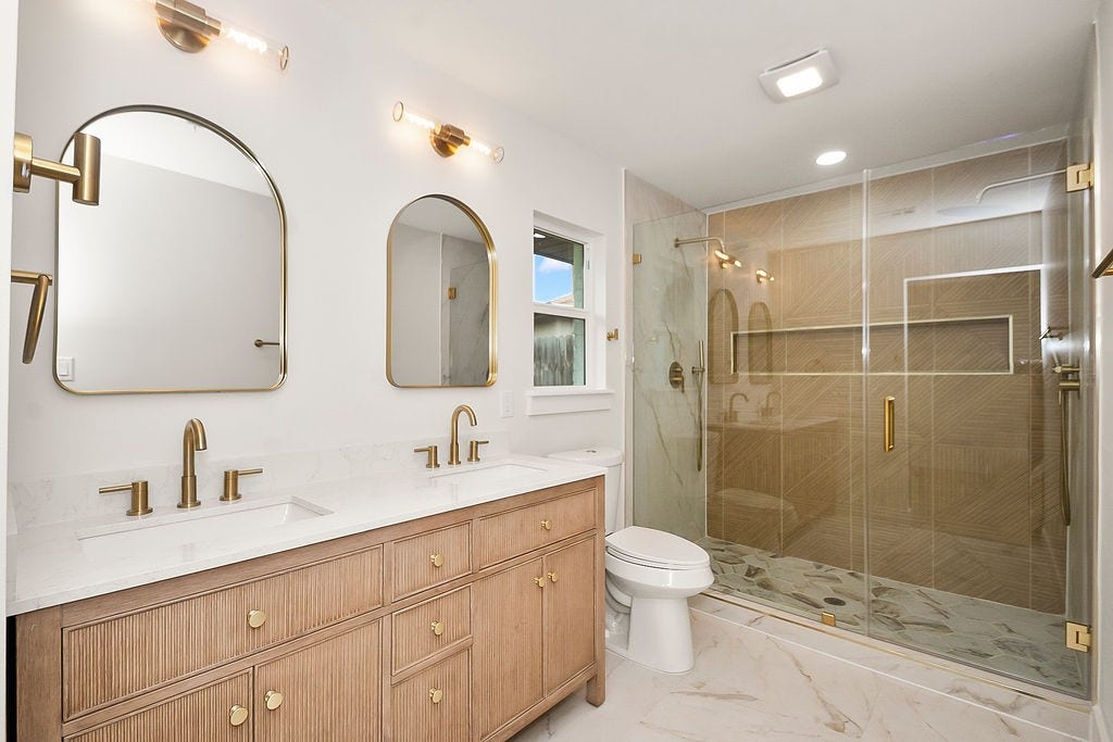 6106 Rutherglenn Drive, Houston, TX 77096 Luxurious spa-inspired primary bathroom with dual vanities, designer finishes, and oversized walk-in shower.
