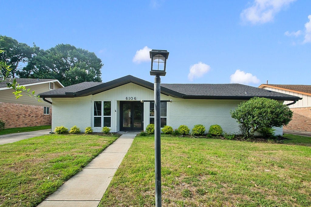 6106 Rutherglenn Drive, Houston, TX 77096 Completely renovated home featuring modern curb appeal, mature landscaping, and an inviting oversized lot.