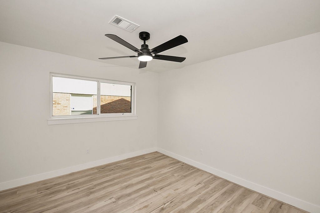6106 Rutherglenn Drive, Houston, TX 77096 Another view of the spacious bedroom offering flexibility for guests, family, or workspace needs.
