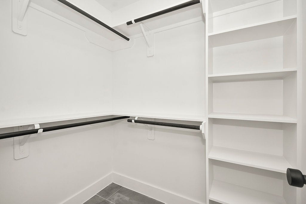 6106 Rutherglenn Drive, Houston, TX 77096 Custom walk-in closet with built-in shelving and exceptional organization space.